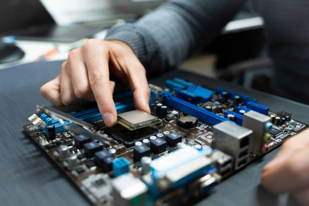 Hands installing a processor on a motherboard